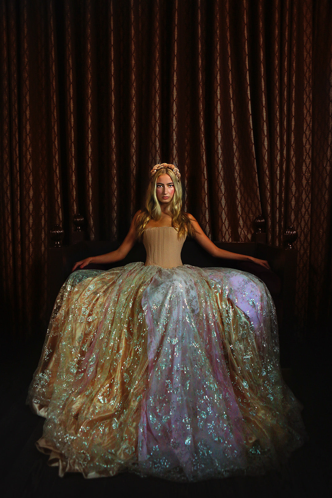 Blonde haired and light-skinned woman wearing a period style Freja bespoke corset with a long skirt.