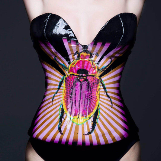 Close-up of a Deborah Brand bespoke corset featuring an image from Adam Bricusse's Scarab painting. 