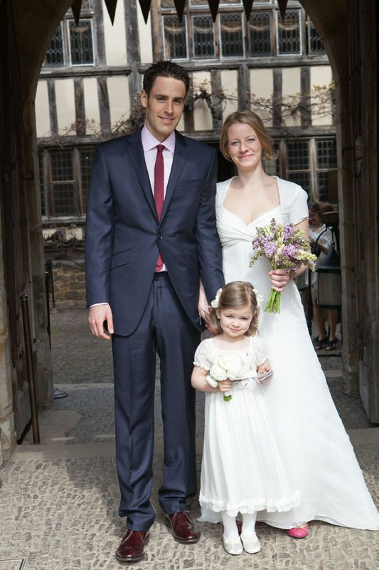 The bride, groom, and a child at Lady Tania Astor's wedding at Hever Castle