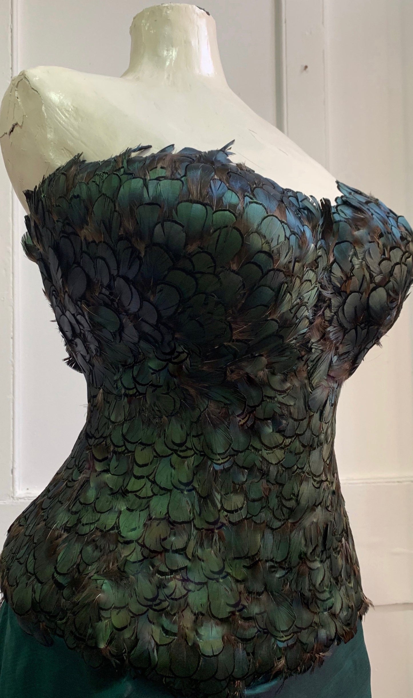Close-up of Deborah Brand peacock feather corset. 